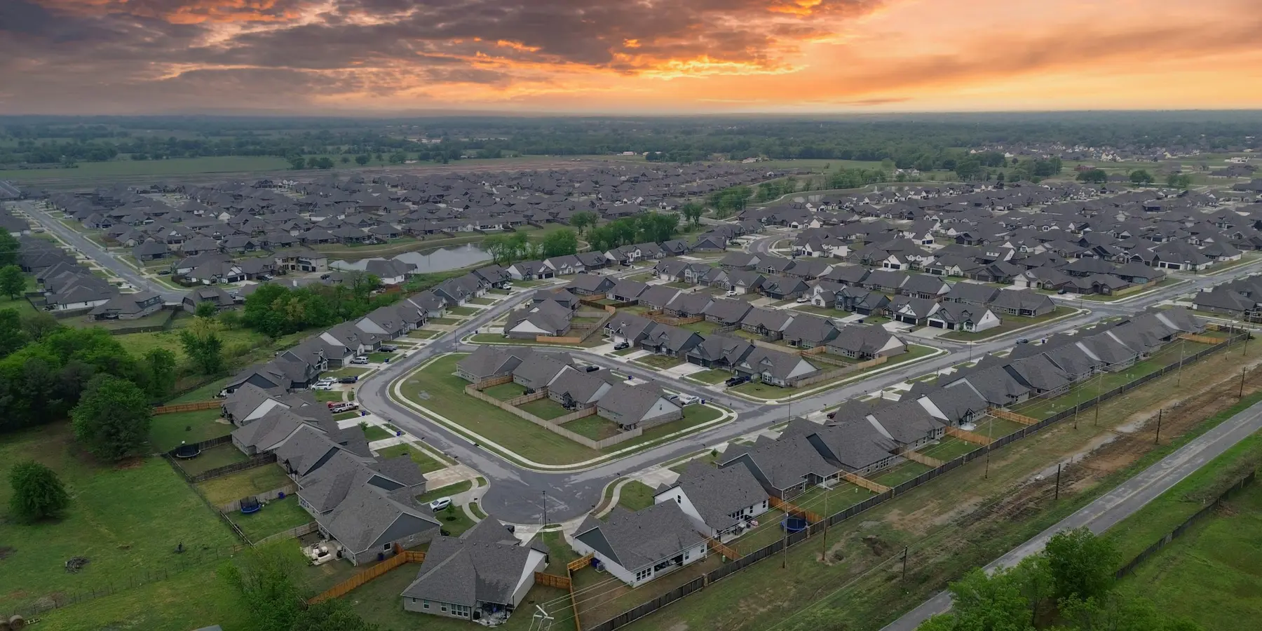 An aerial view of a residential neighbourhood at sunset