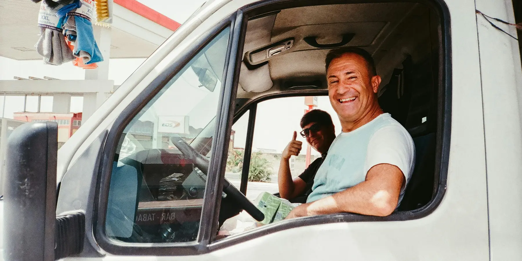 A driver taking a call from the cab of a van