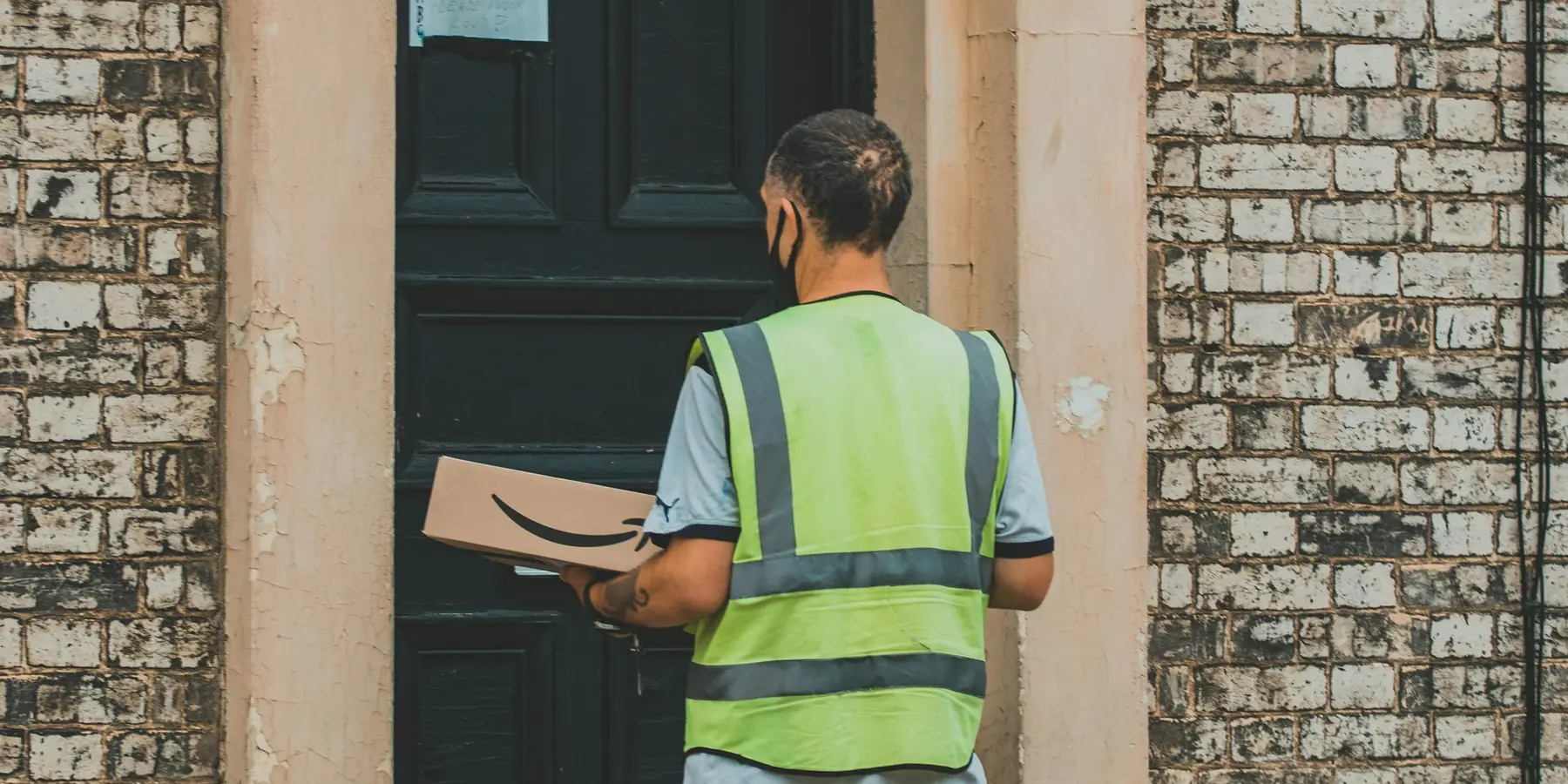 A tradesperson at a customer's door with paperwork