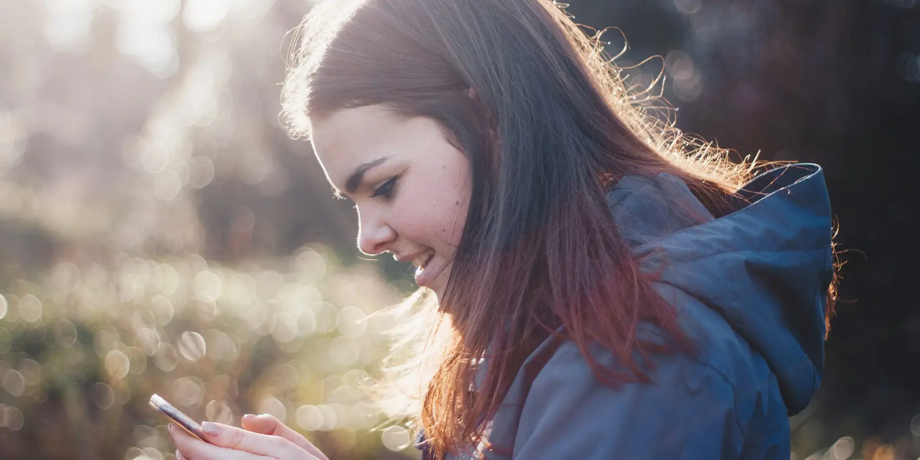 A phone in hand, outdoors