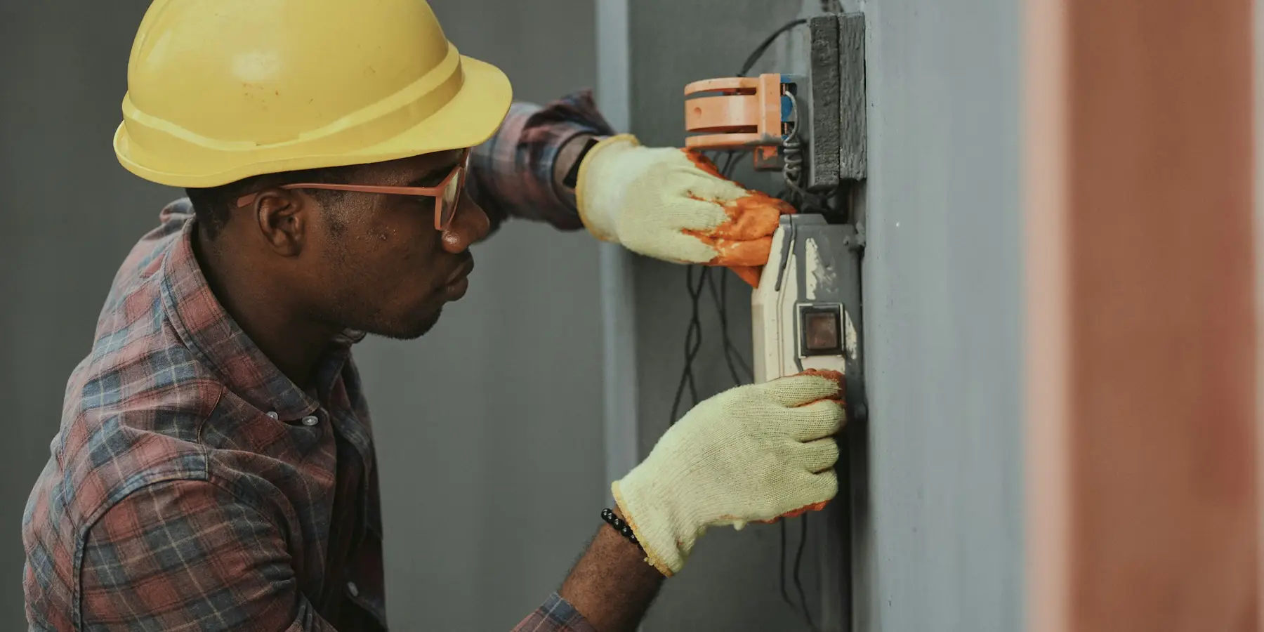 An electrician testing a wall panel