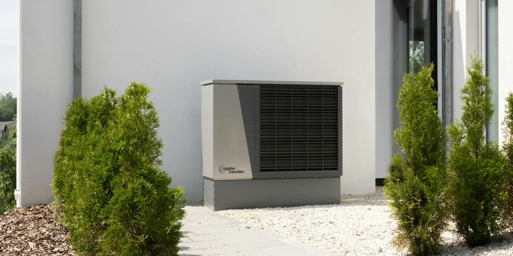 A residential heat pump beside a house